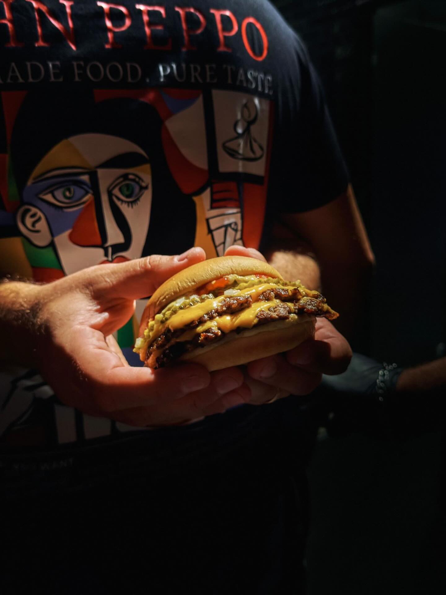 John Peppo burger in hand